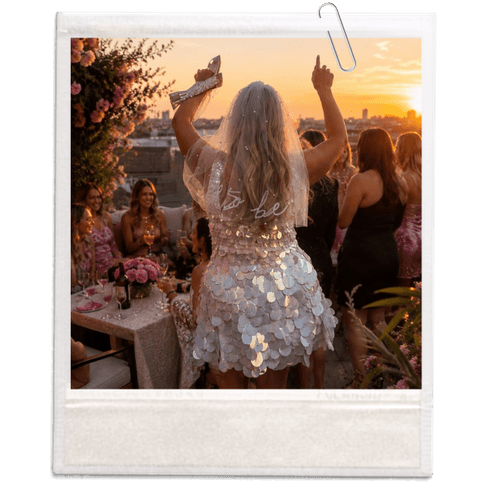 Hen party group celebrating on a rooftop at sunset