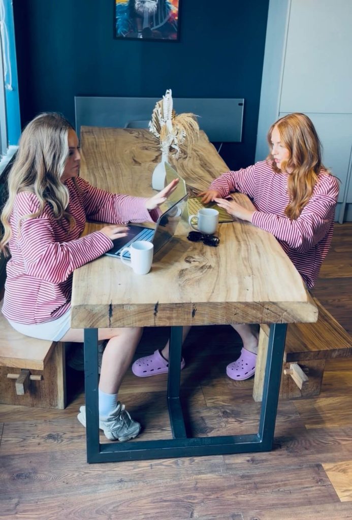 Two women planning a hen weekend together at a table